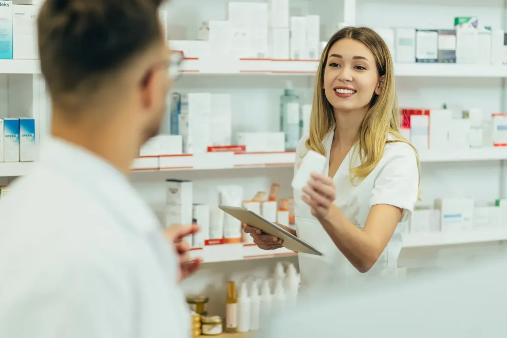 Pharmacist consulting with customer